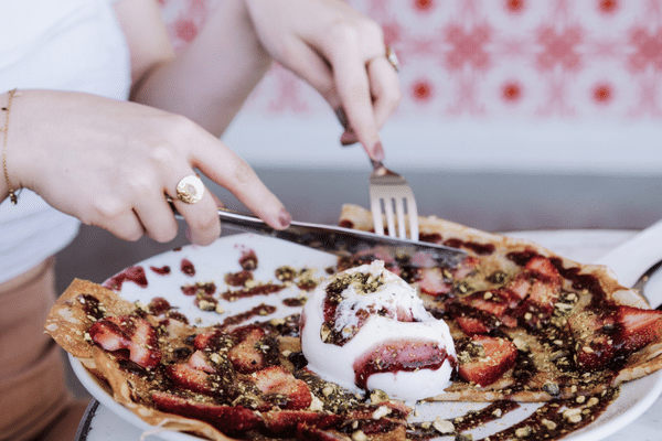 A woman eating La Delicieuse Crepe